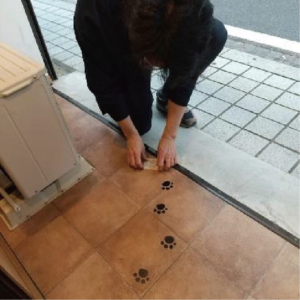 床に足跡のカッティングシートを貼り付け
